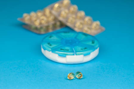 fish oil capsules blisters on blue background