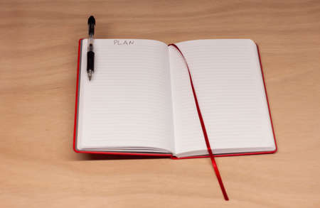 opened red notebook with page for plan