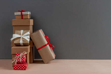 gift boxes with red bow-knot on dark craft backgroundの写真素材