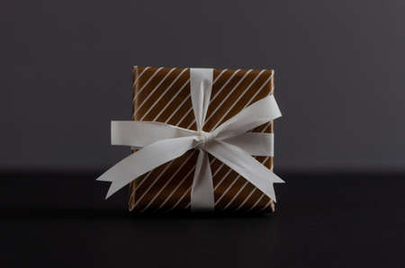 craft gift box with bow knot on dark backgroundの写真素材