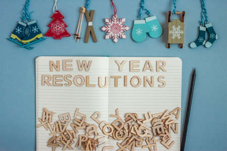 christmass decoration and open notebook for new year resolutions