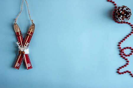wooden toy ski and christmass decoration. Blue paper craft background. Flat lay. Copy spaceの写真素材