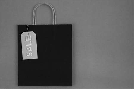black and white paper bag with sale tag on craft backgroundの写真素材