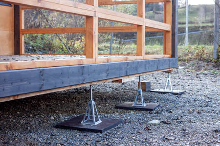 aluminium jack stands supporting painted wooden constructionの写真素材