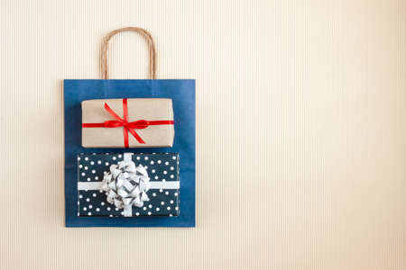 Blue paper bag with wrapped gifts top view. Copy space. Top view.の写真素材