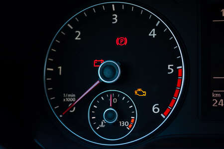 part of car dashboard with speedometer and amount of gasoline