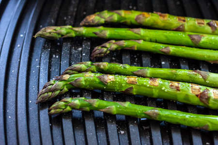 green fresh asparagus on electric grill home cookingの写真素材