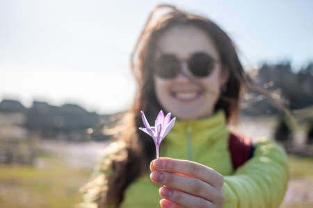 young beautiful woman walking outside in nature windy sunny day