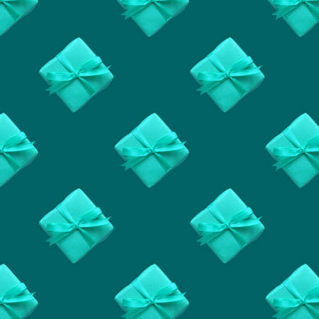 blue gift box with bow-knot pattern on green backgroundの写真素材
