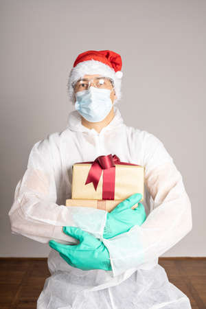 man in protective white suit and Santa Claus hatの写真素材
