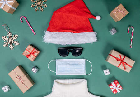 red hat mask and white sweater flat lay shape of Santa Slausの写真素材
