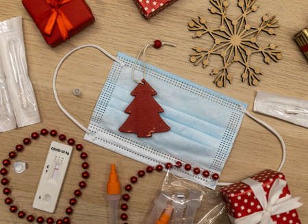 christmas decoration and covid test with mask on table