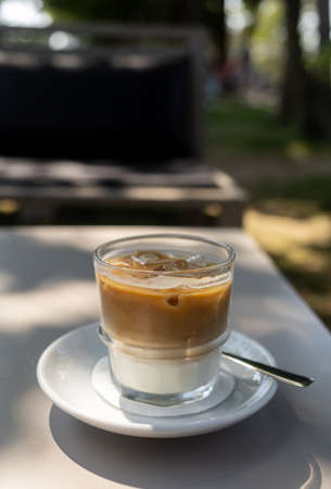 glass of iced coffee on the table at summer terraceの写真素材