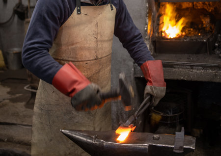 blacksmith forging with hammer blank metal partの写真素材