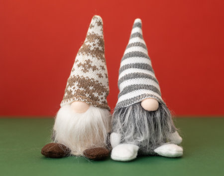 three little christmas gnomes gonks on red backgroundの写真素材