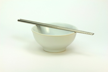 Ceramic white bowl with metalic chopsticksの写真素材