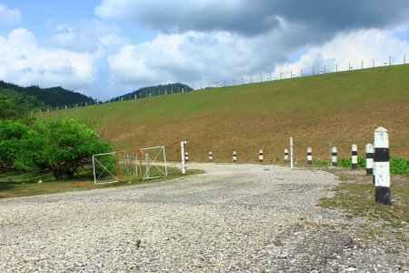 Damaged asphalt Road along Protective Damの写真素材