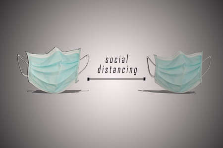 Social distancing to prevent coronavirus concept. Two face masks put far away with textの写真素材