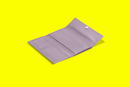 Fashionable leather women's wallet on a yellow background. added copy space for text.