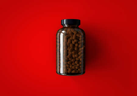 3D vitamins bottle isolated on red background. suitable for your design element.の写真素材