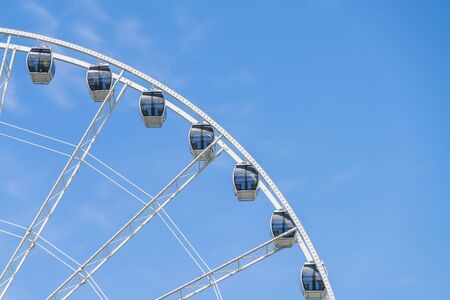 white modern ferris wheel  with blue sky background.の写真素材