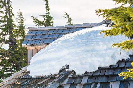 snow on the roof while melting on the sunny day.の写真素材