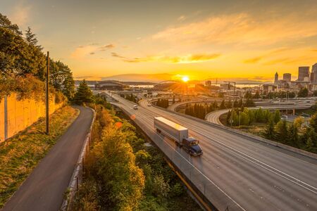 Seattle skylines and Interstate freeways converge with Elliott Bay and the waterfront background of in sunset time, Seattle, Washington State, USA..の写真素材