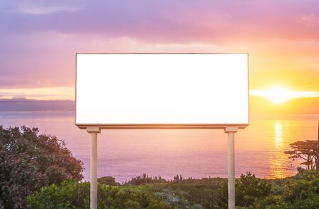 blank  white billboard for outdoor advertising  at sunset ,ready for product display montage,advertisement.の写真素材
