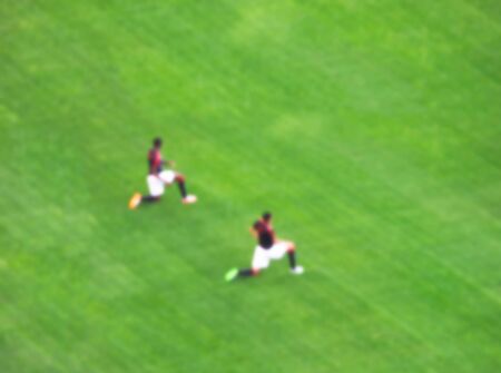 soccer player warm up in the green grass before the game start in big soccer stadium.-blurred picture..の写真素材