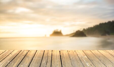 empty wooden deck table top Ready for product display montage with sea,sunset sky and beach background..の写真素材