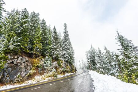 Empty road to the mountain with snow covered landscape in winter season. .の写真素材