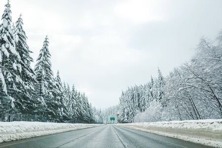 Empty road with high snow level covered landscape in winter season..
