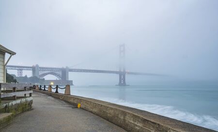 scenic view of Golden gate in the in the dusk with lighting and reflection on the water and fog,San...