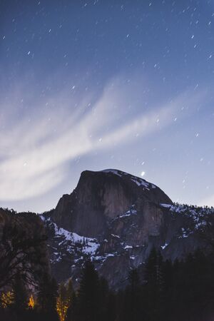 scene of half dome with sky at night before full moon set in Yosemite National park,California,usa.の写真素材