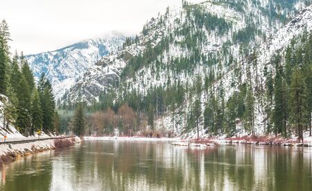 the snow mountain with reflection on a lake in winter.の写真素材