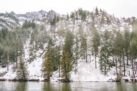 the snow mountain with reflection on a lake in winter.の写真素材