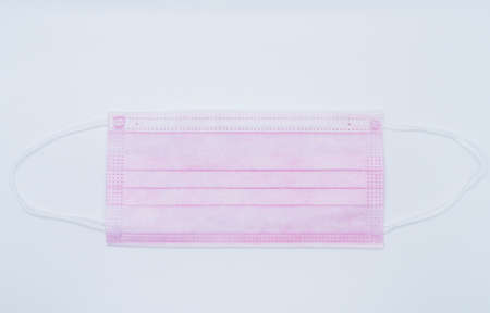 pink face masks isolated on white background.の写真素材