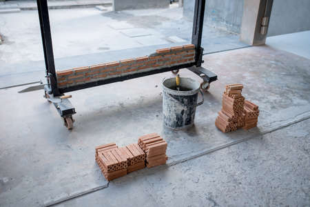 brick on the shelf for contraction fast and clean with tool has a saw and measuring tape.の写真素材