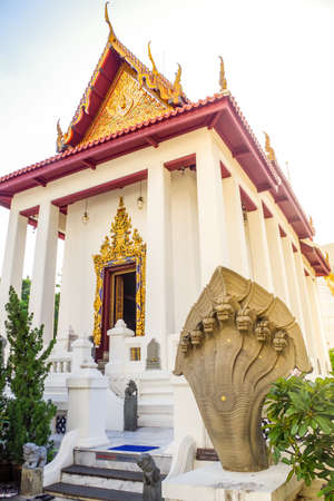 White Thai temple with a Sculpture.