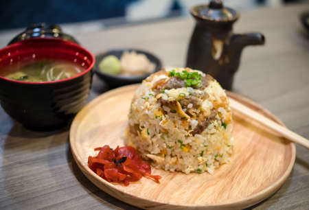 Fried rice with salmon and soup with topping and soy sauceの写真素材