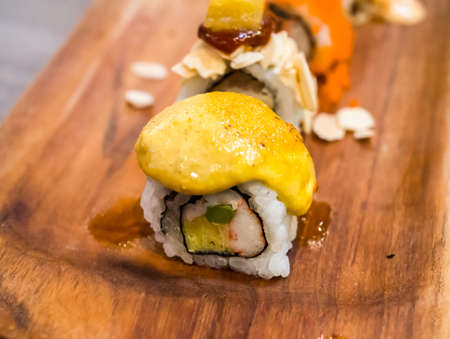 Sushi on wood tray top with yellow curry.の写真素材