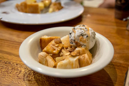 Ice cream, cookies and toasted diced toast served in a serving dish is a dessert after dinner.の写真素材