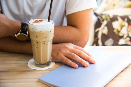 an menu and ice coffee with man hand background