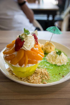 an Gelatin dessert menu ice cream with whip cream and fruit and cookie.の写真素材