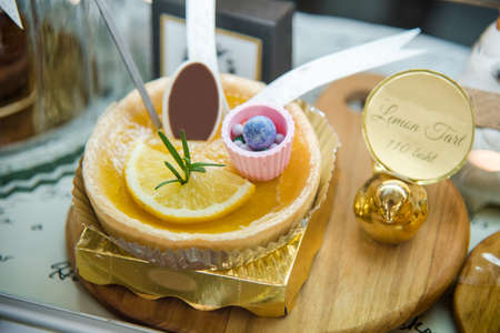 Lemon tart on the wooden plate in shelf for sale