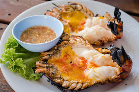 A giant river prawn is a Thai food recipe eat with Spicy sauce made from fish sauce, chilli, garlic mix together.の写真素材