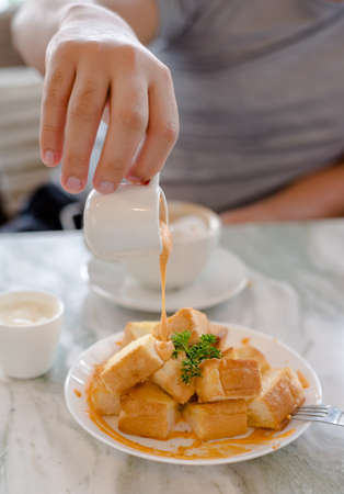 Dessert afternoon tea is a Thai tea sauce with small toast  and ice creamの写真素材