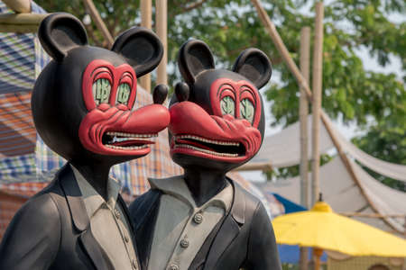 Red mouse in black suit look like laughingの写真素材