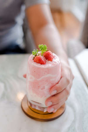 handle a strawberry milkshake ready to drinkの写真素材