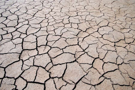 Cracks in the soil show how the Riverbed dried out の写真素材